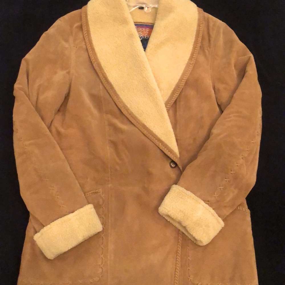 Suede coat with Sherpa like or Sherpa lining. I am not sure. Warm